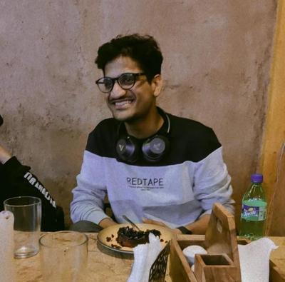 Image of the author smiling and eating desserts